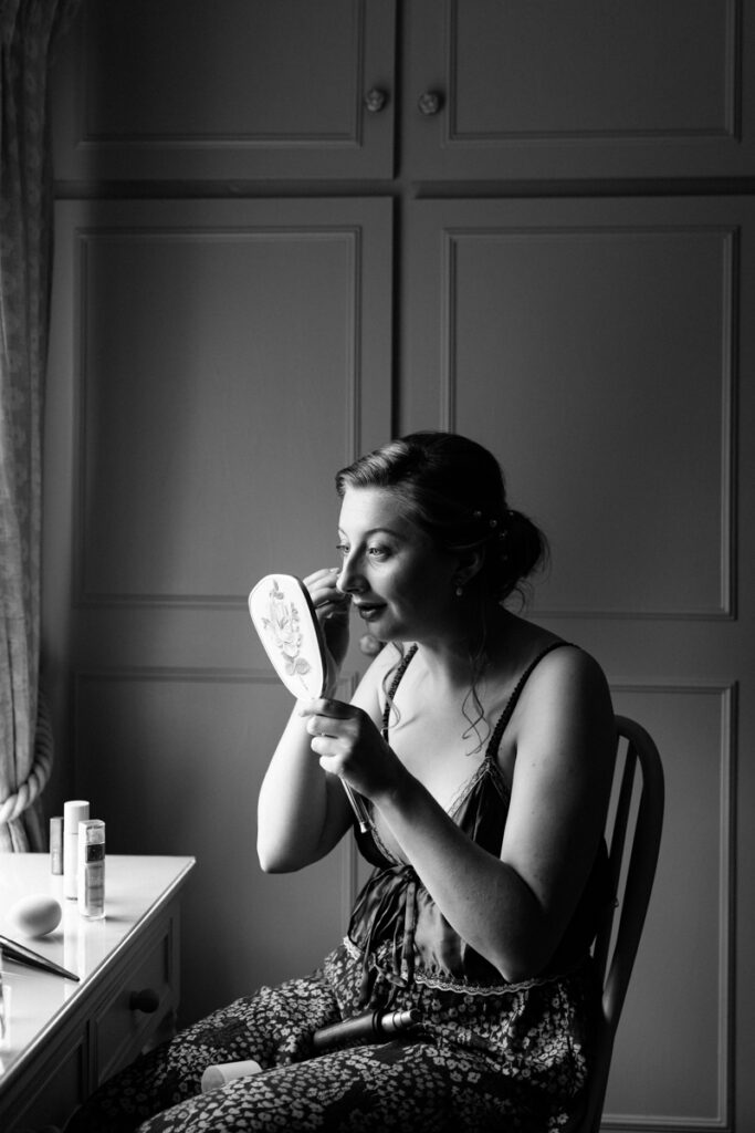 Bride applying make up at The Normans York
