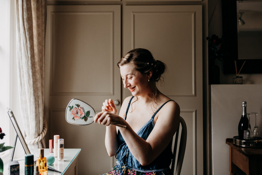 Bride applying make up at The Normans York
