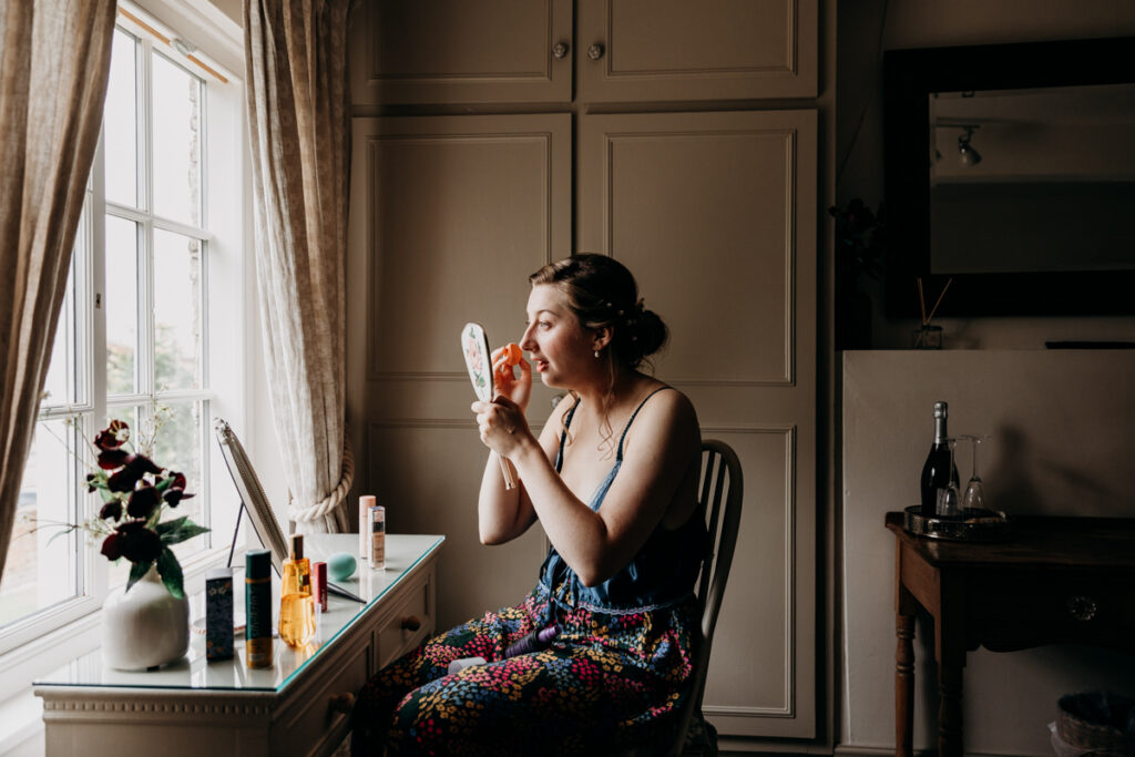 Bride applying make up at The Normans York