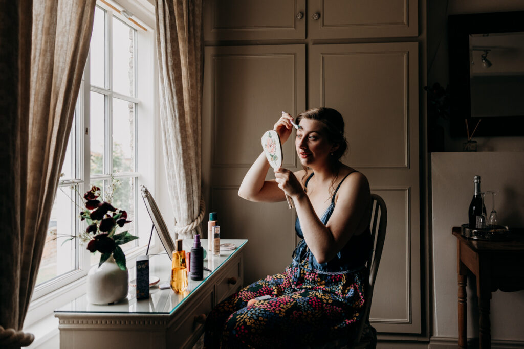 Bride applying make up at The Normans York