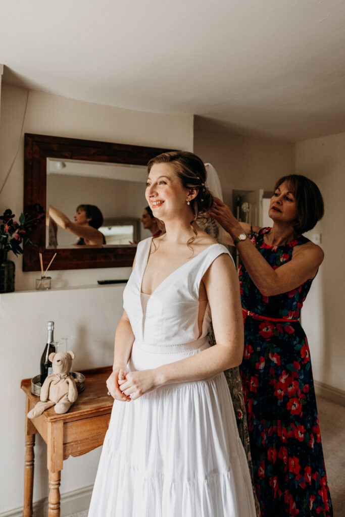 Mum putting bride's veil in at The Normans York