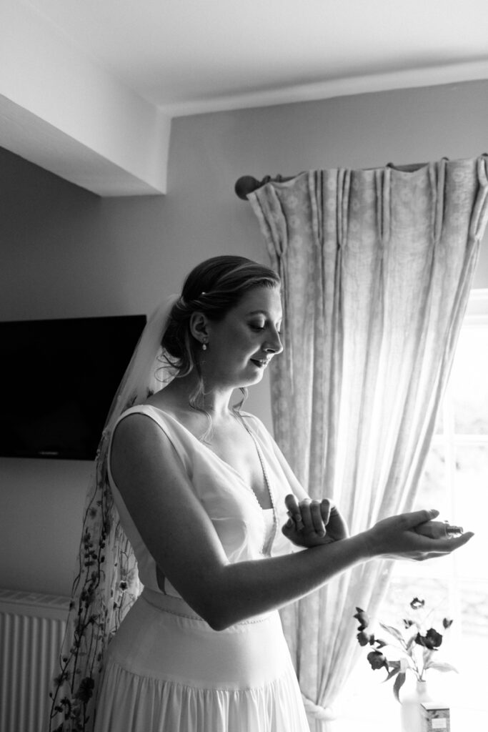 Bride putting on perfume at The Normans York