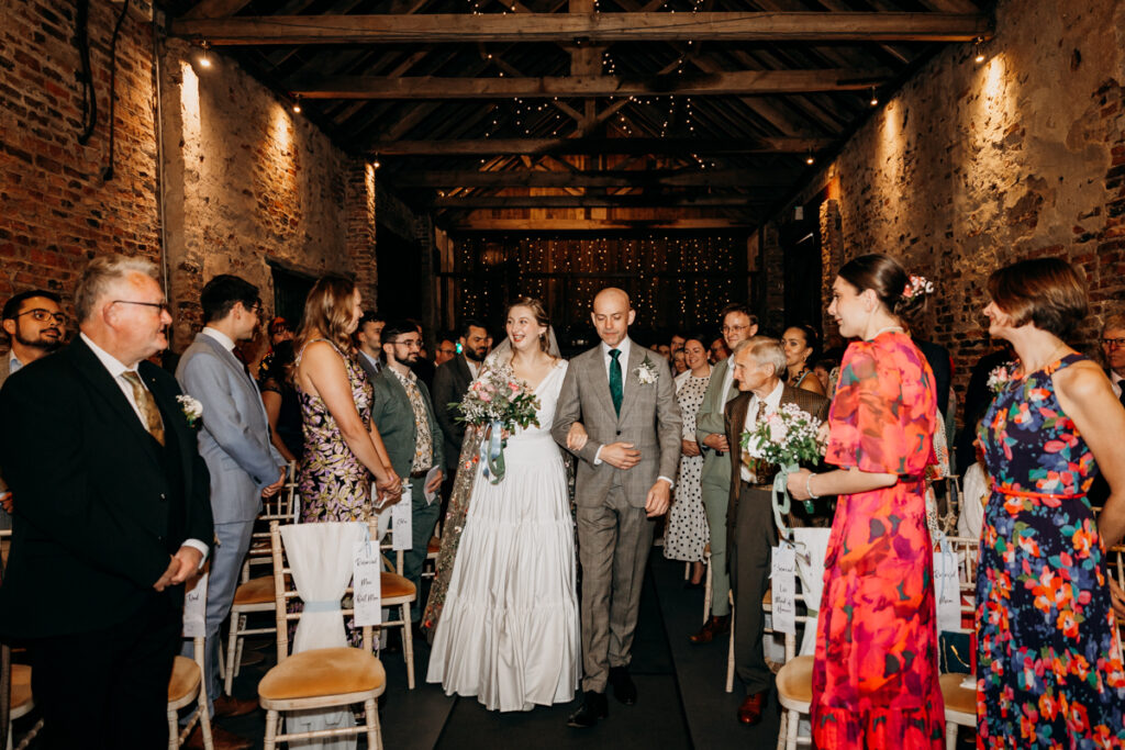 Bride walking down aisle at The Normans York