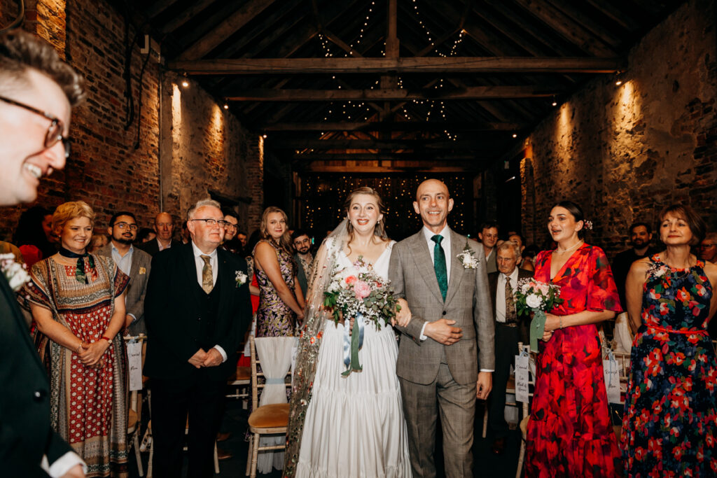 Bride walking down aisle at The Normans York