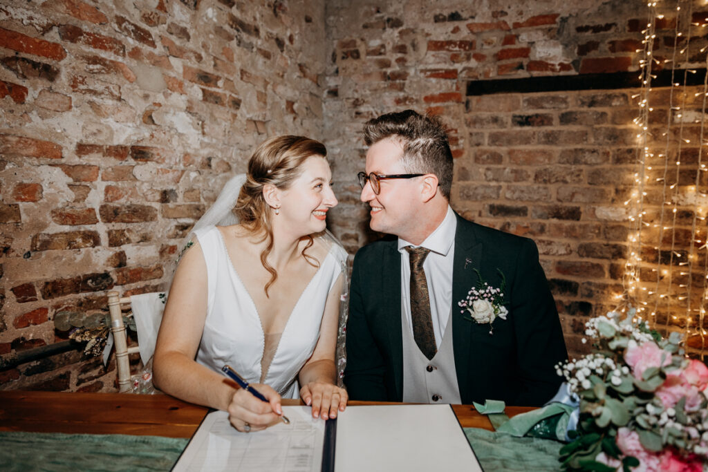 Couple signing register at The Normans York