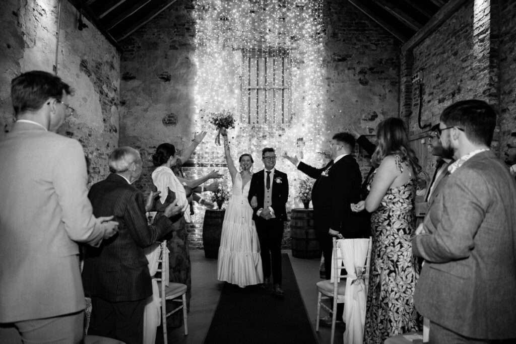Bride and groom celebrating in black and white at The Normans York