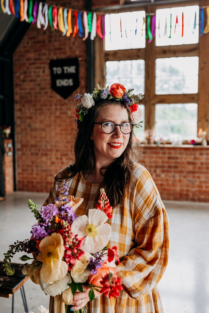 Bride in colourful flower crown at The Giraffe Shed