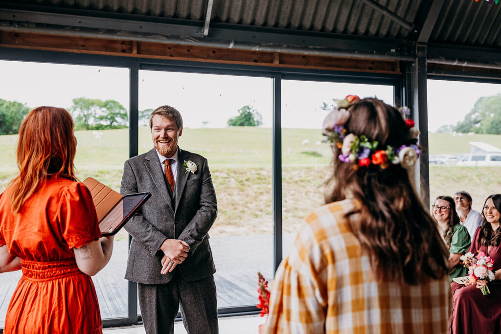 Groom smiling in wedding ceremony at The Giraffe Shed