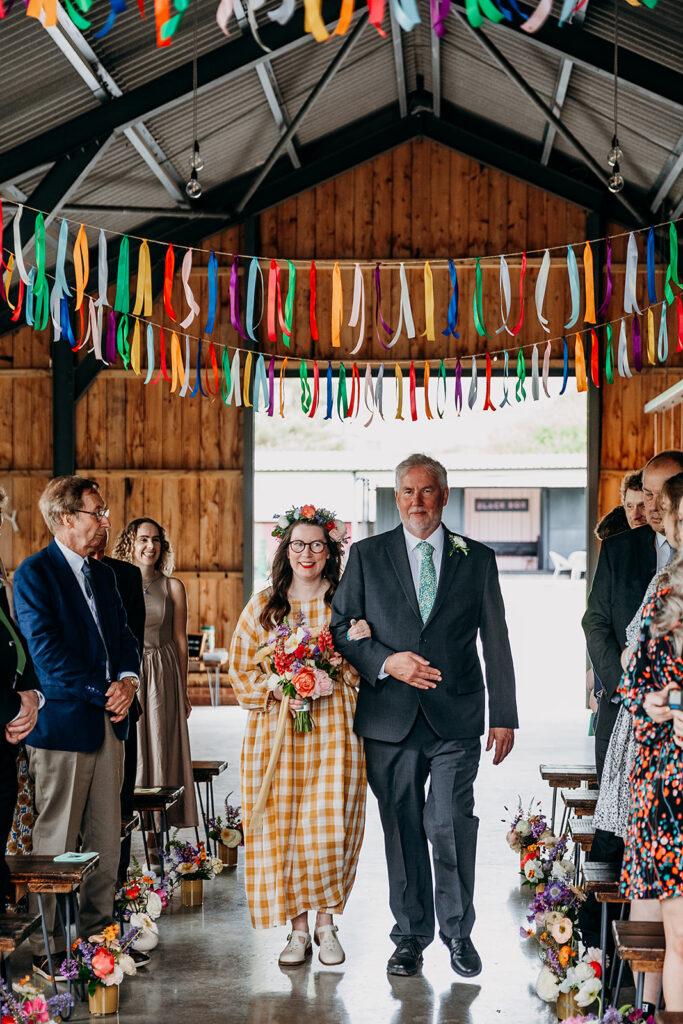 Bride walking down aisle at The Giraffe Shed