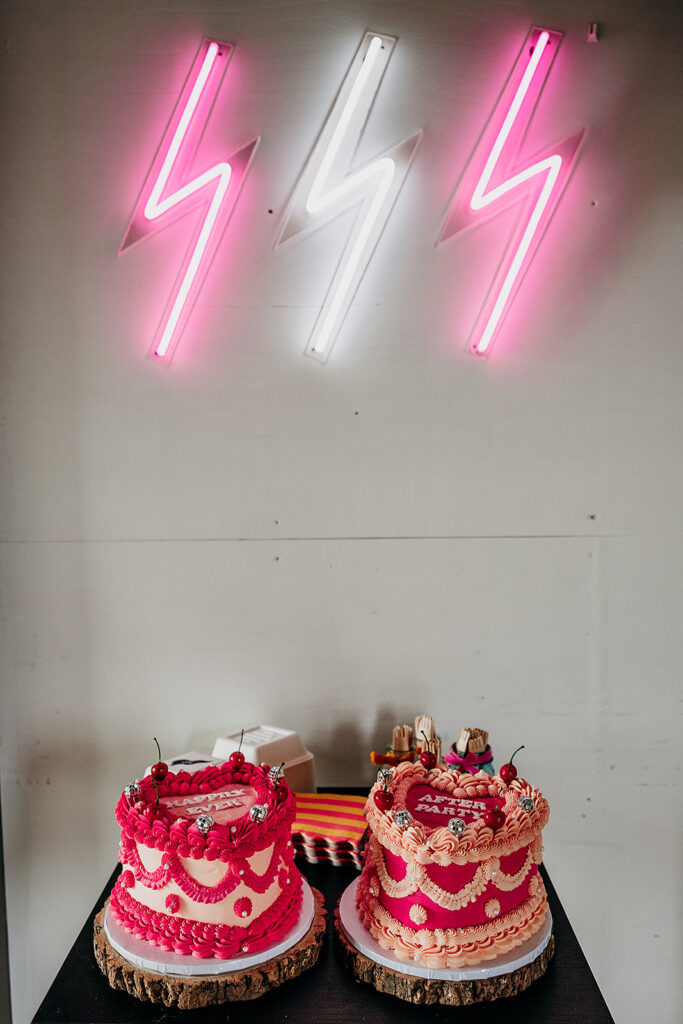 Pink cakes with neon signs at The Giraffe Shed