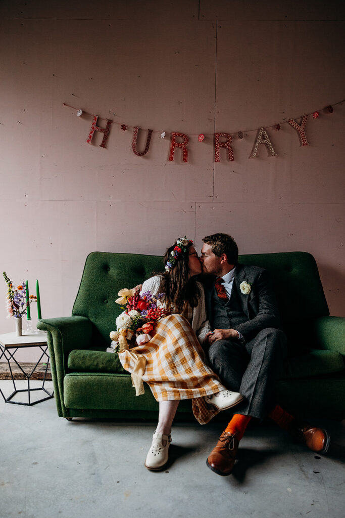 Bride and groom on sofa at The Giraffe Shed