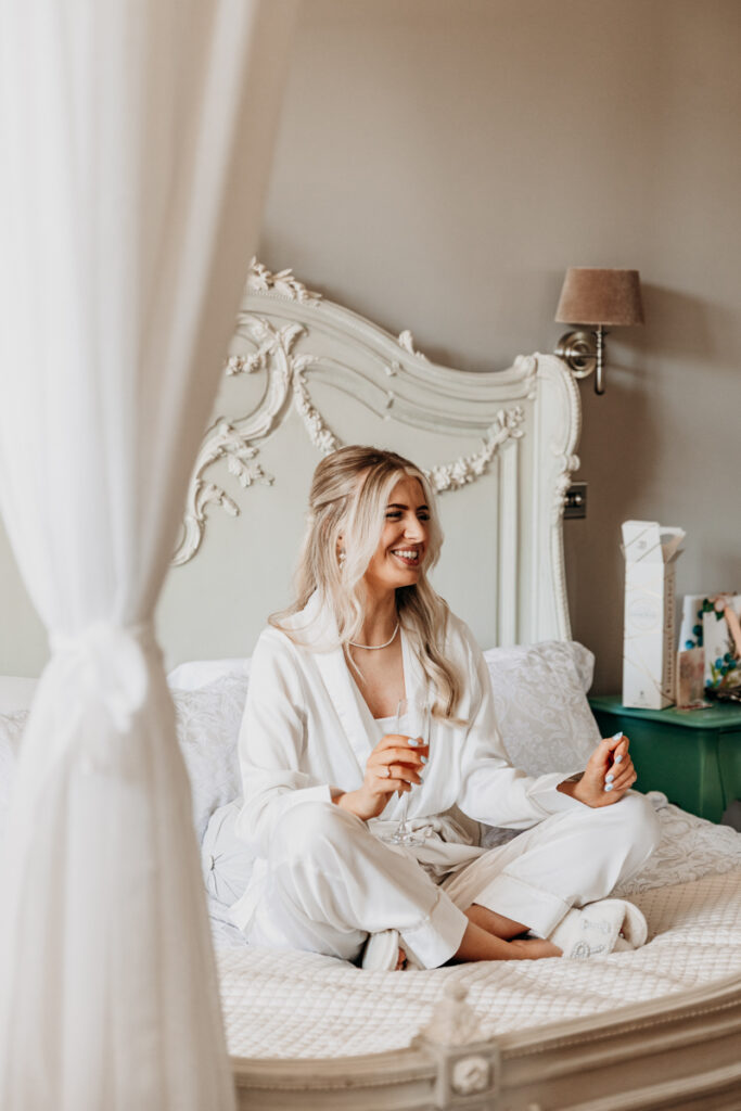Bride smiling in bed at Thicket Priory