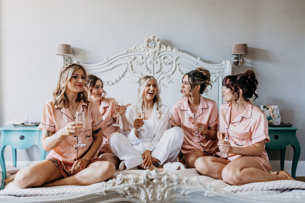 Bride and bridesmaids in bed at Thicket Priory