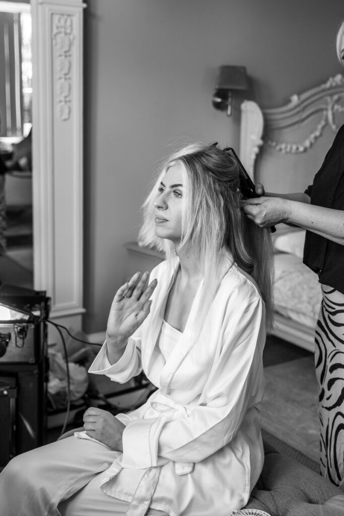 Bride having make up done in black and white at Thicket Priory