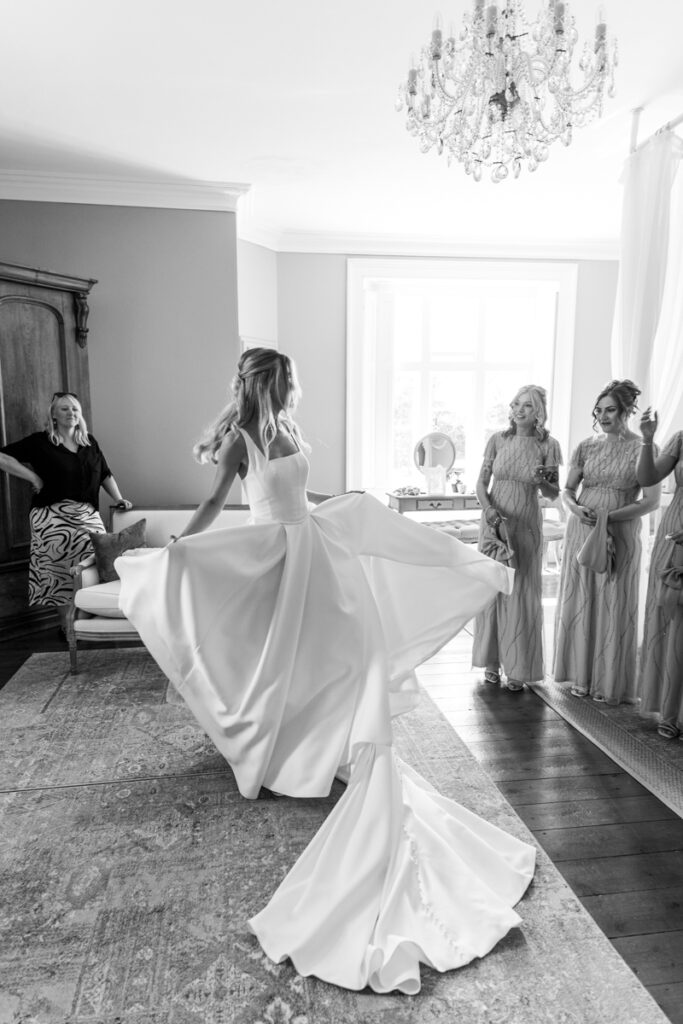 Bride twirling in wedding dress at Thicket Priory