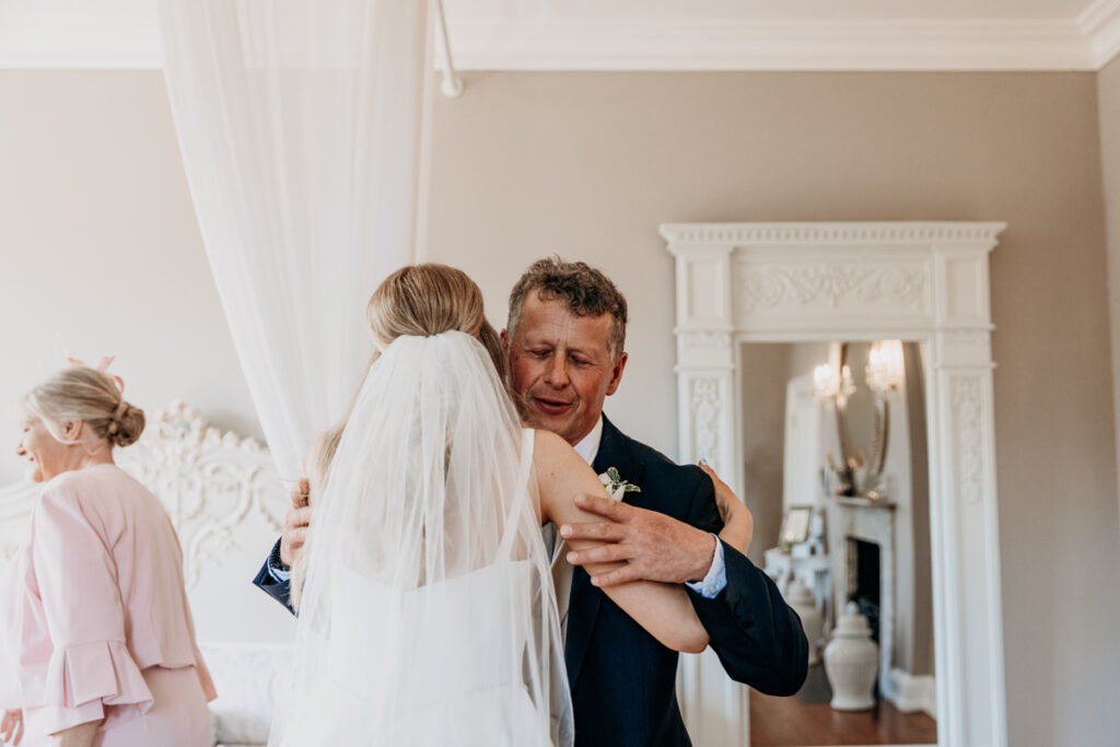 Bride hugging dad at Thicket Priory