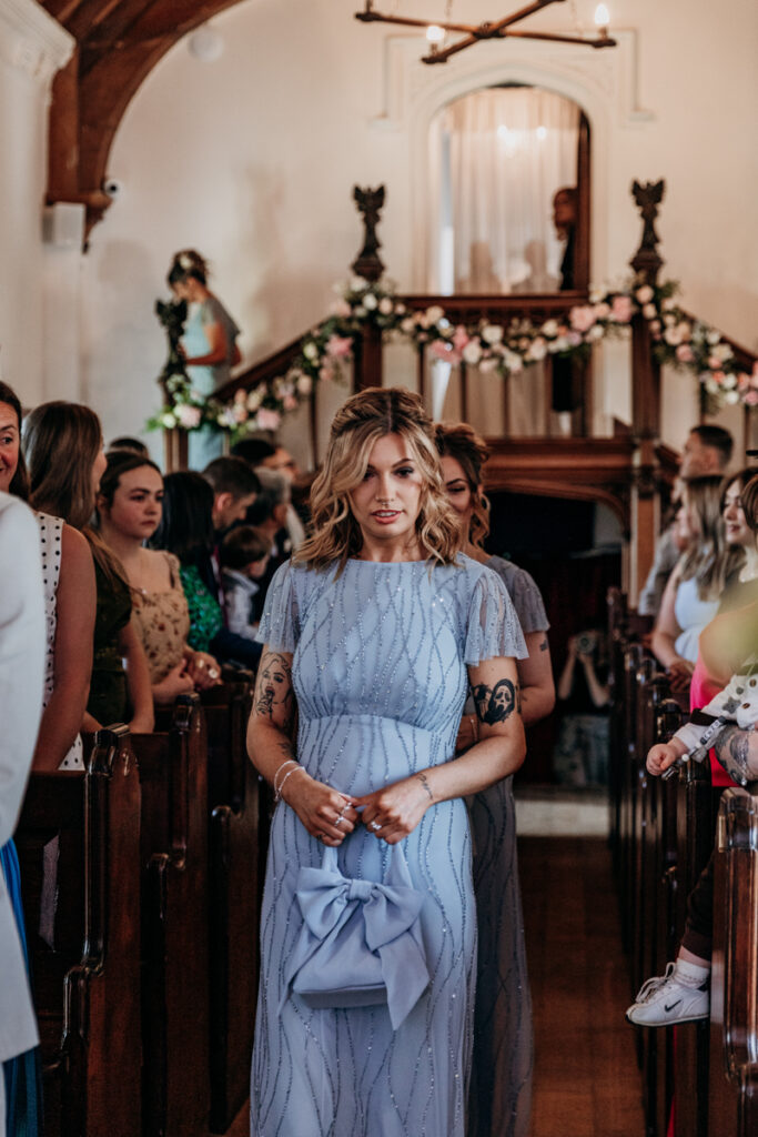 Bridesmaids walking down aisle at Thicket Priory