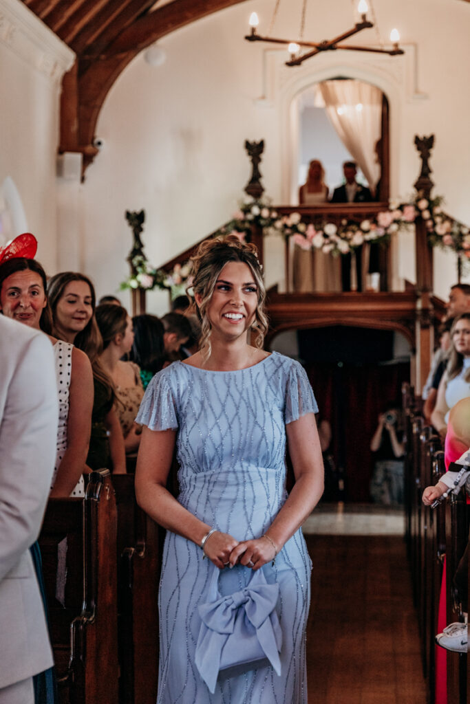Bridesmaids walking down aisle at Thicket Priory