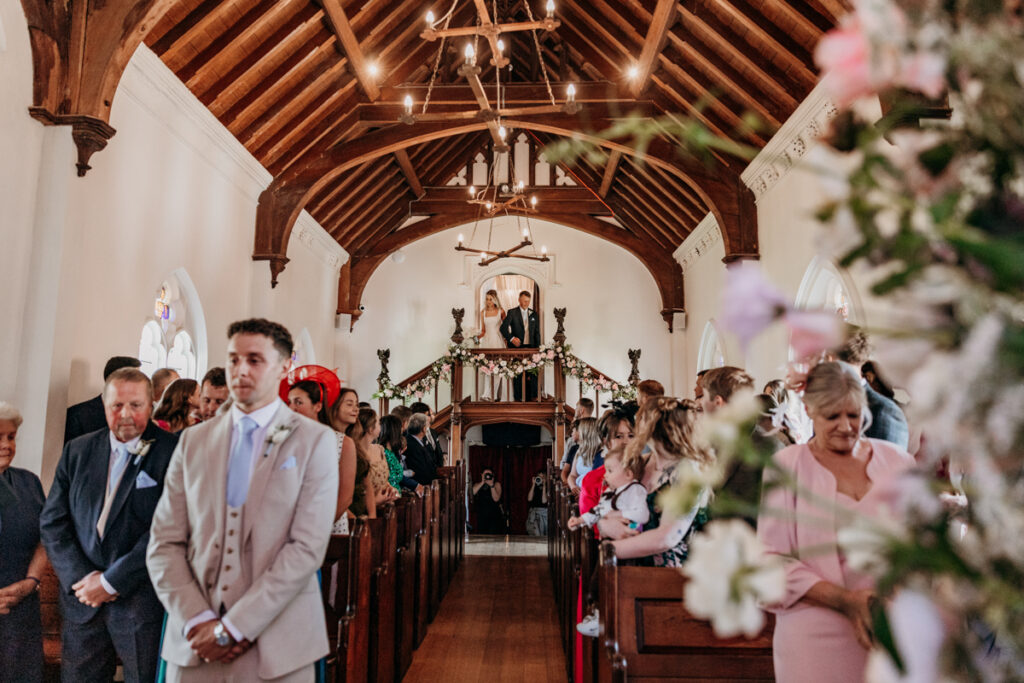 Bride walking down steps in Chapel at Thicket Priory