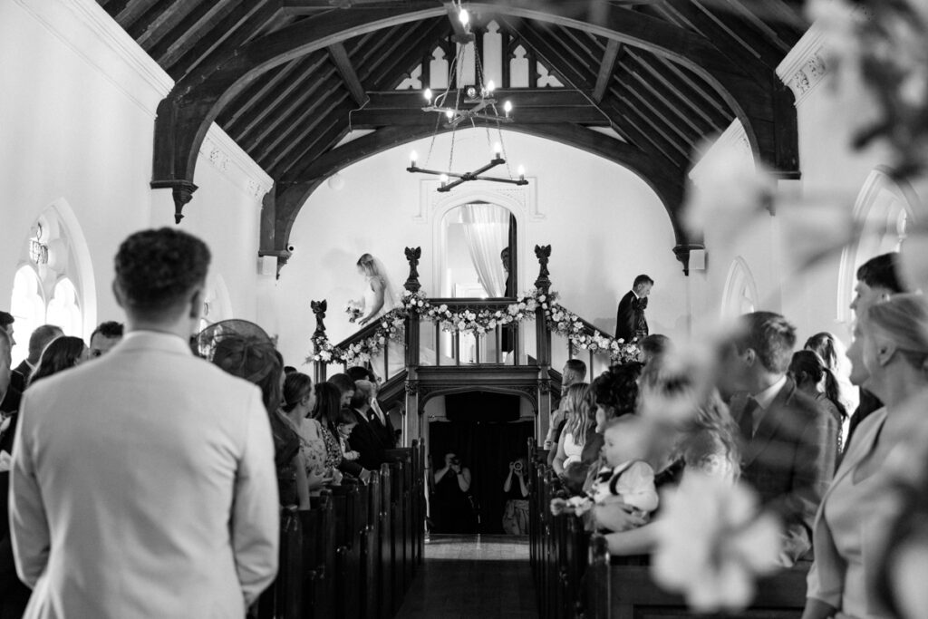 Bride walking down steps in Chapel at Thicket Priory