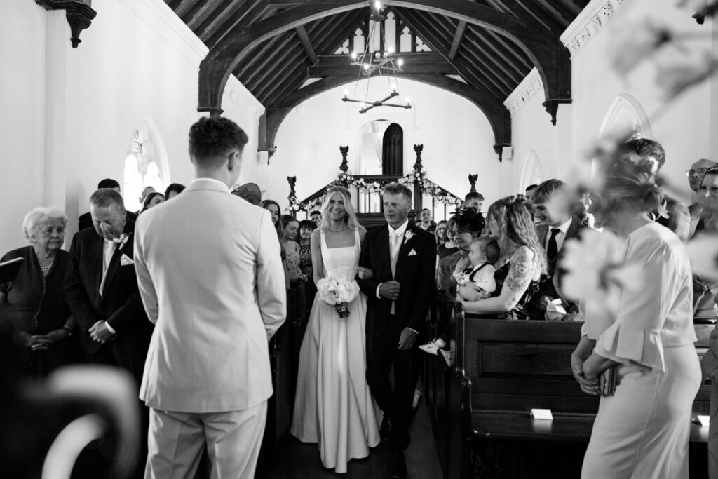 Bride walking down aisle at Thicket Priory