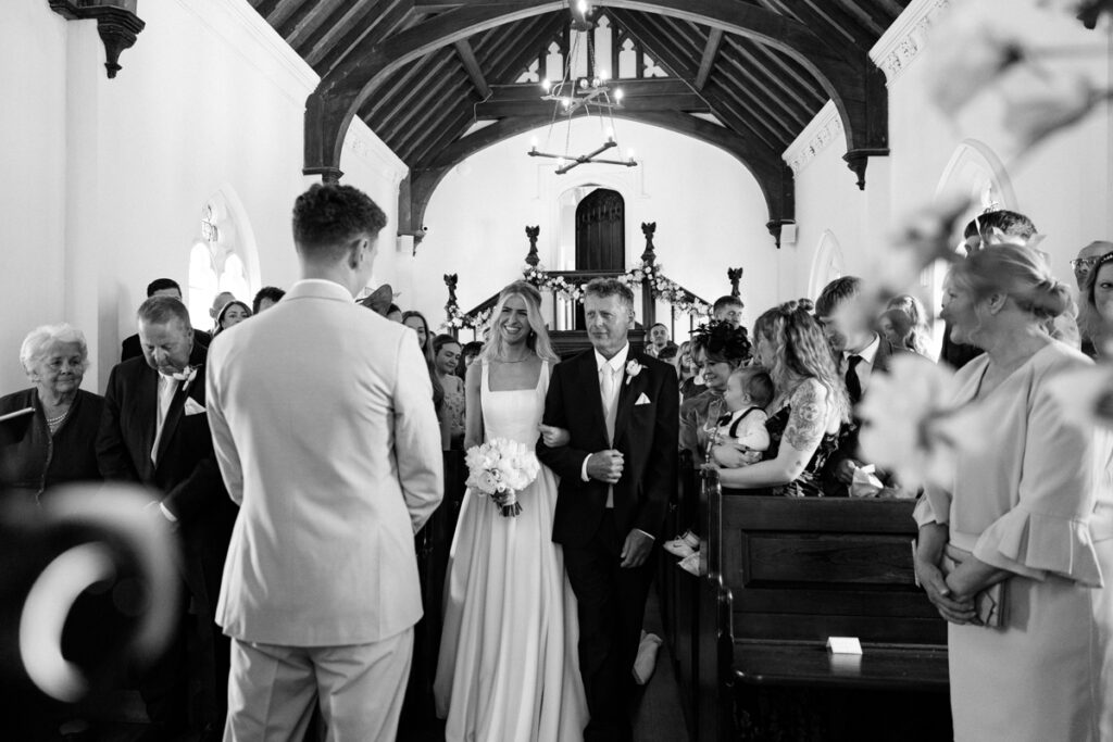 Bride walking down aisle in Chapel at Thicket Priory