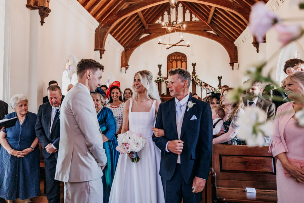 Bride walking down aisle at Thicket Priory