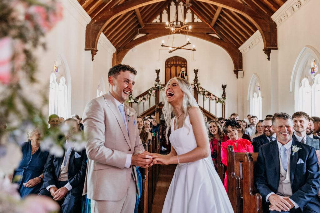 Couple laughing in ceremony at Thicket Priory