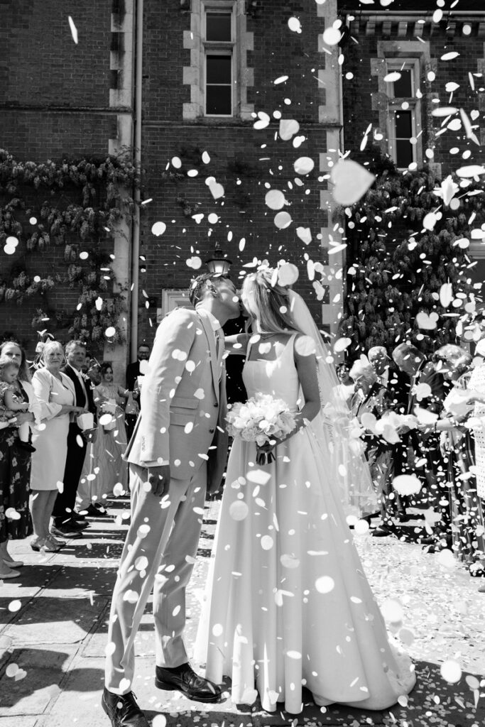 Confetti kiss in black and white at Thicket Priory