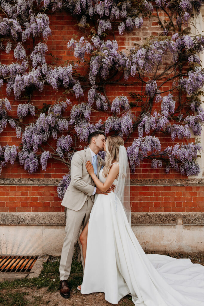 Bride and Groom by Wisteria at Thicket Priory