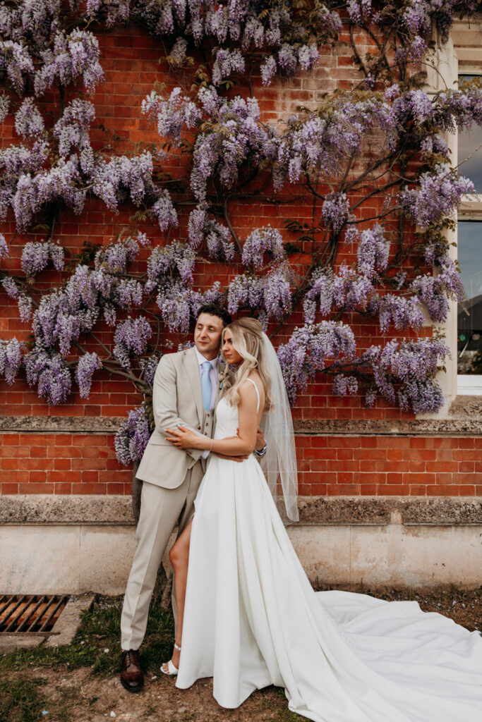 Bride and Groom by Wisteria at Thicket Priory