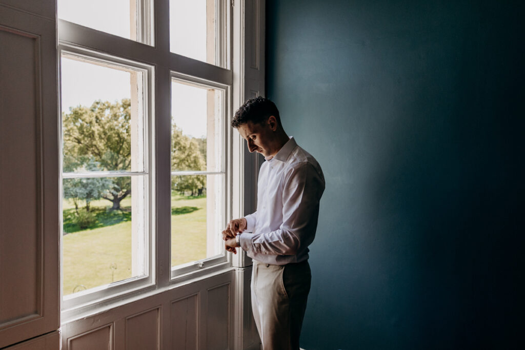 Groom getting dressed at Thicket Priory