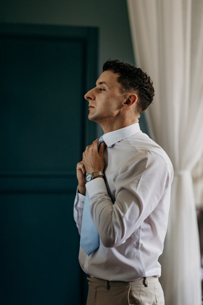 Groom getting dressed at Thicket Priory