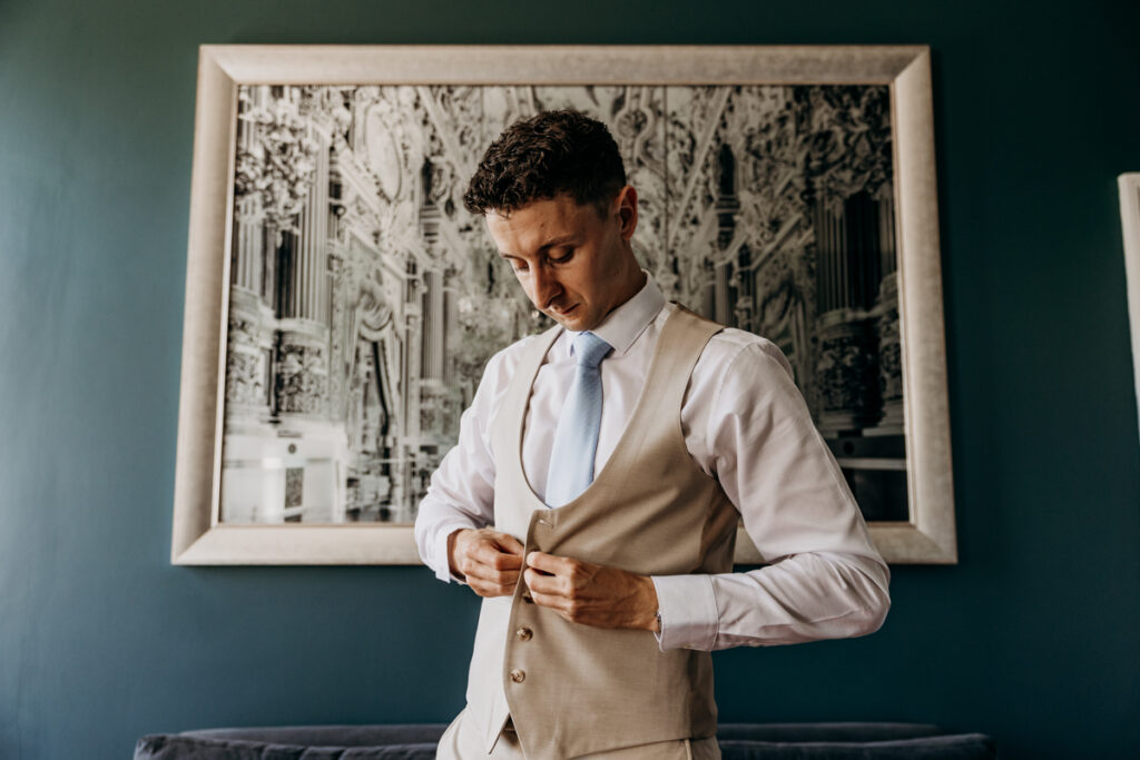 Groom getting dressed at Thicket Priory