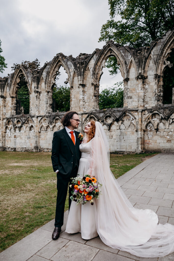 Bride and Groom in front of ruins in York Museum Gardens