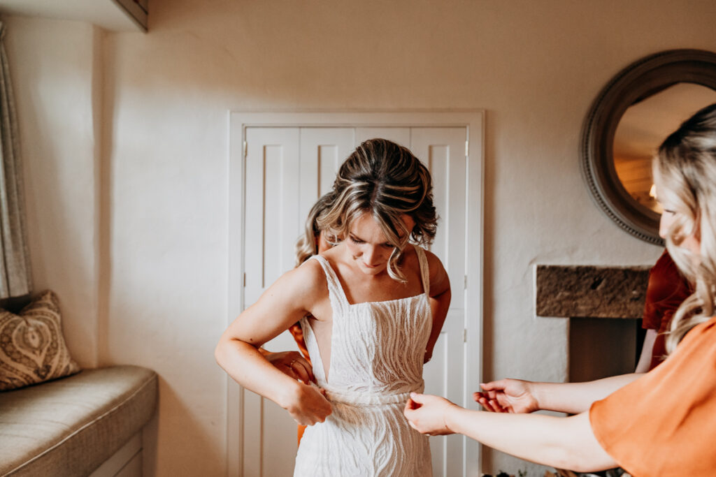 Bride getting dress on at Middleton Lodge