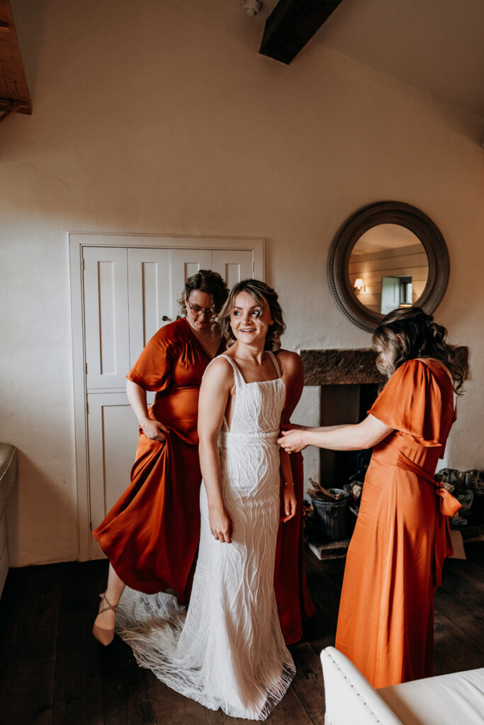 Bride getting dressed at Middleton Lodge