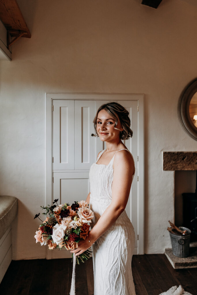 Bride with flowers before ceremony at Middleton Lodge
