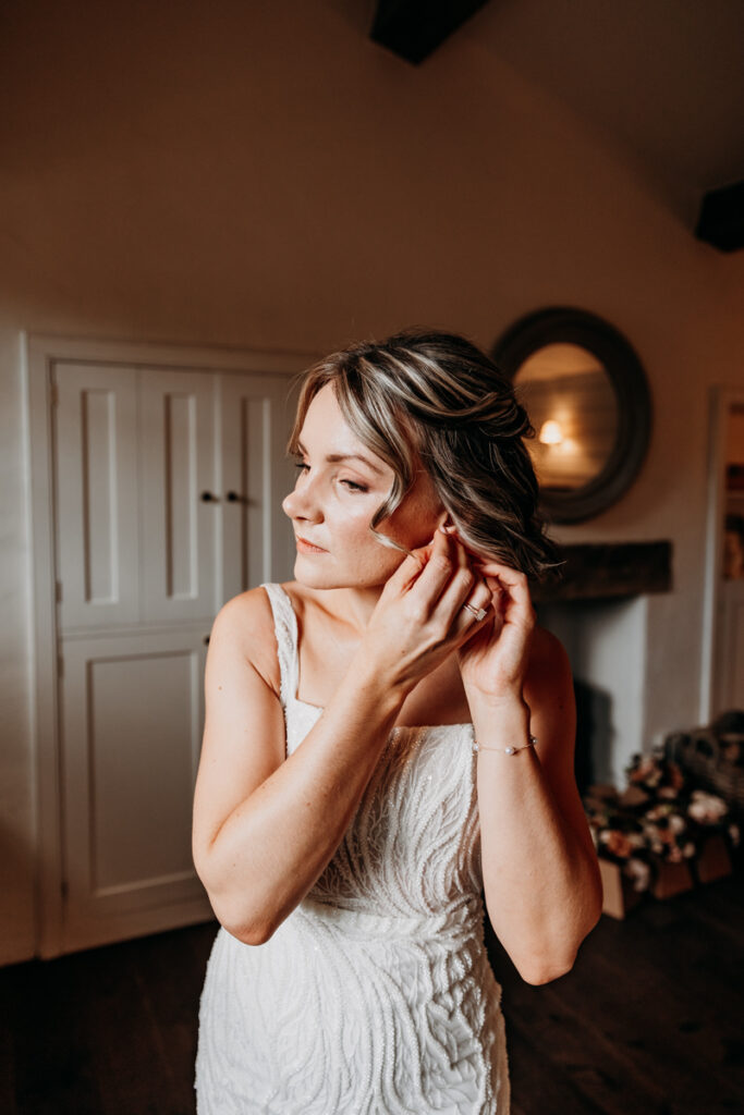Bride putting earrings in at Middleton Lodge