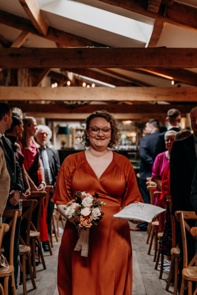Bridesmaid walking down aisle at Middleton Lodge