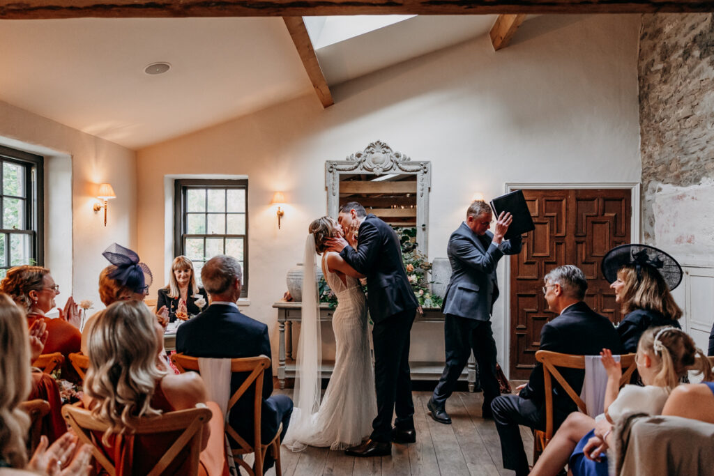 Wedding ceremony first kiss at Middleton Lodge