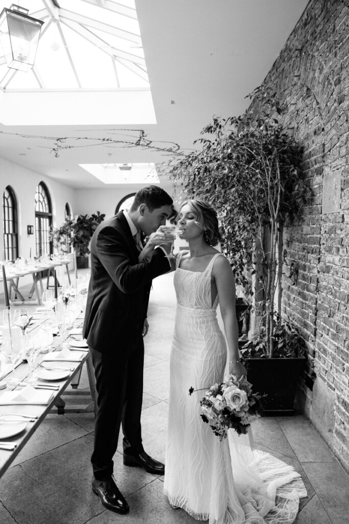 Bride and groom drinking champagne at Middleton Lodge