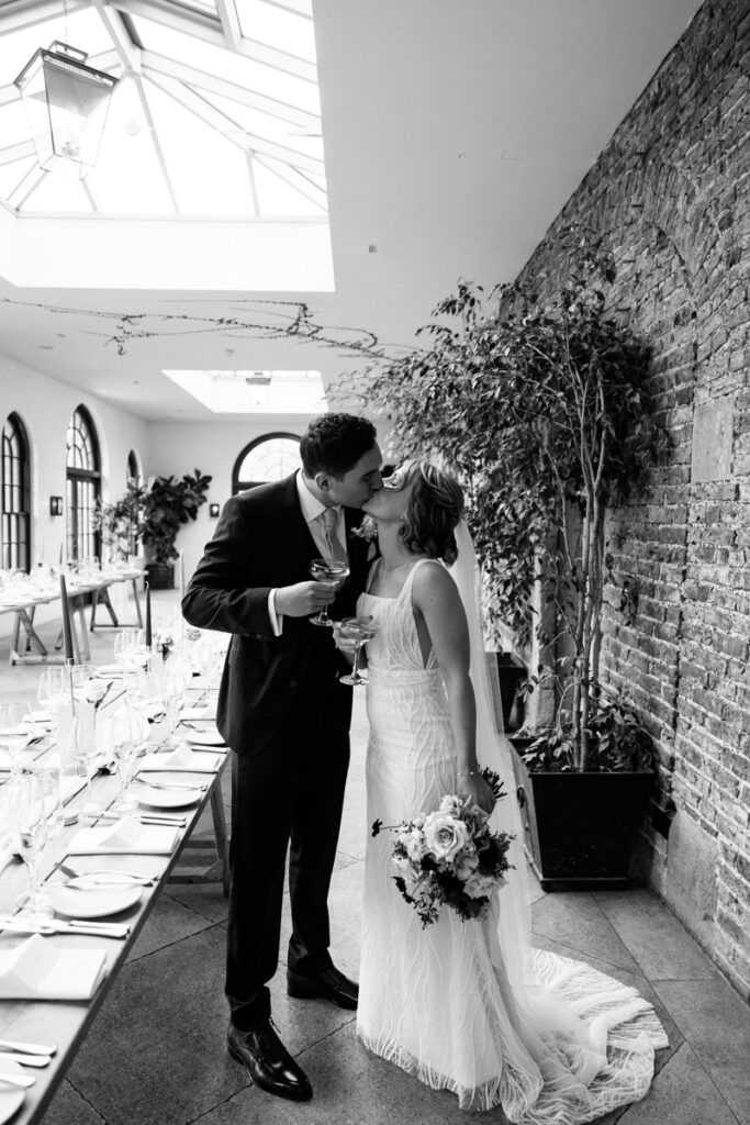Bride and groom kissing in The Fig House at Middleton Lodge