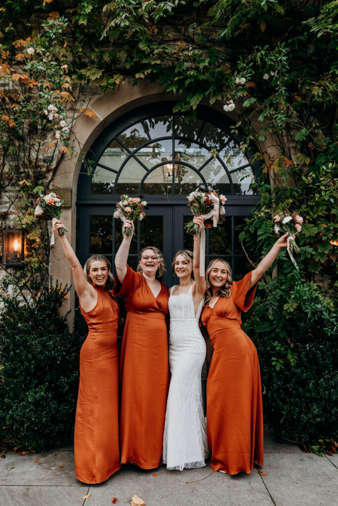 Bridesmaids with arms in the air at Middleton Lodge