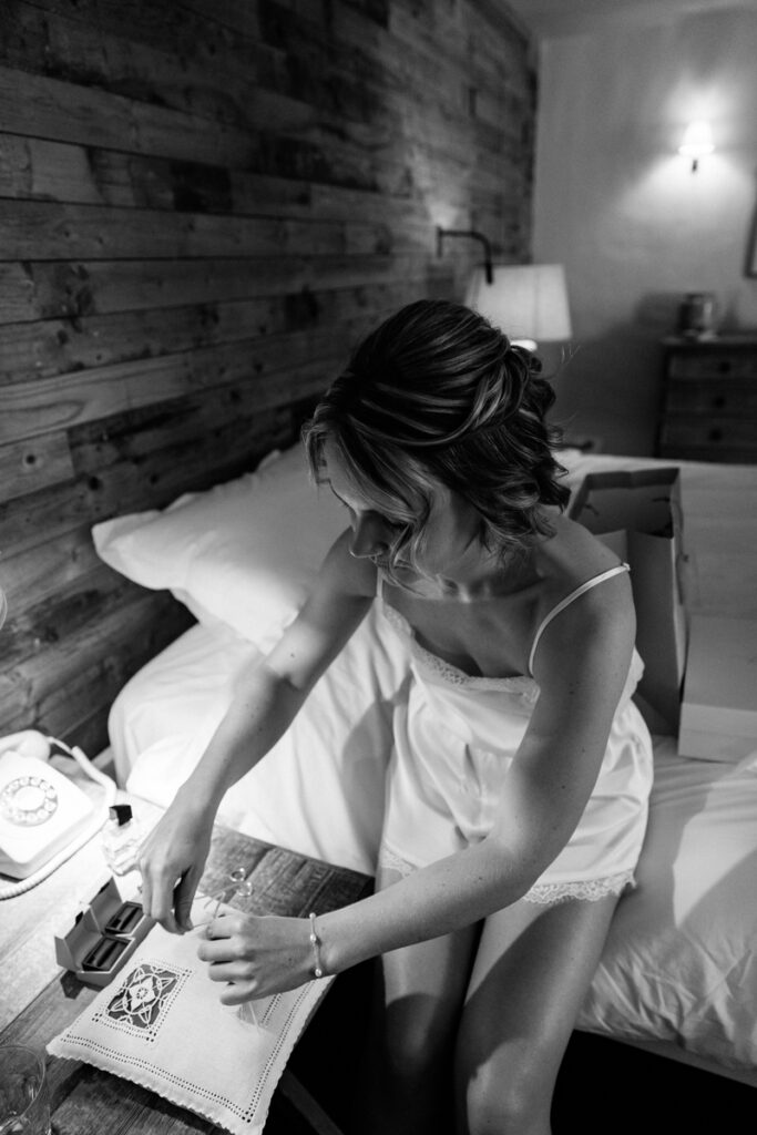 Bride tying rings to cushion