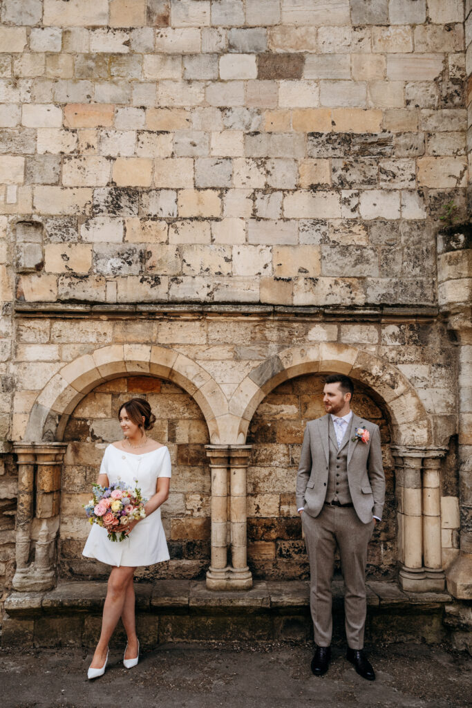 Bride and Groom in front of historic wall in York