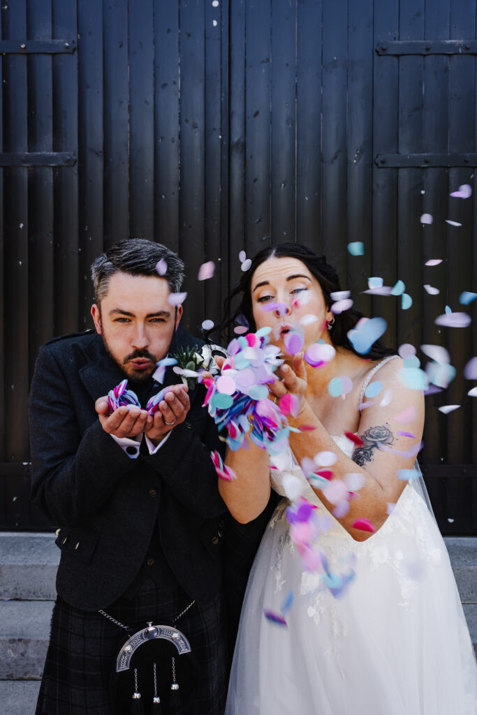 Bride and Groom blow confetti at The Engine Works Glasgow
