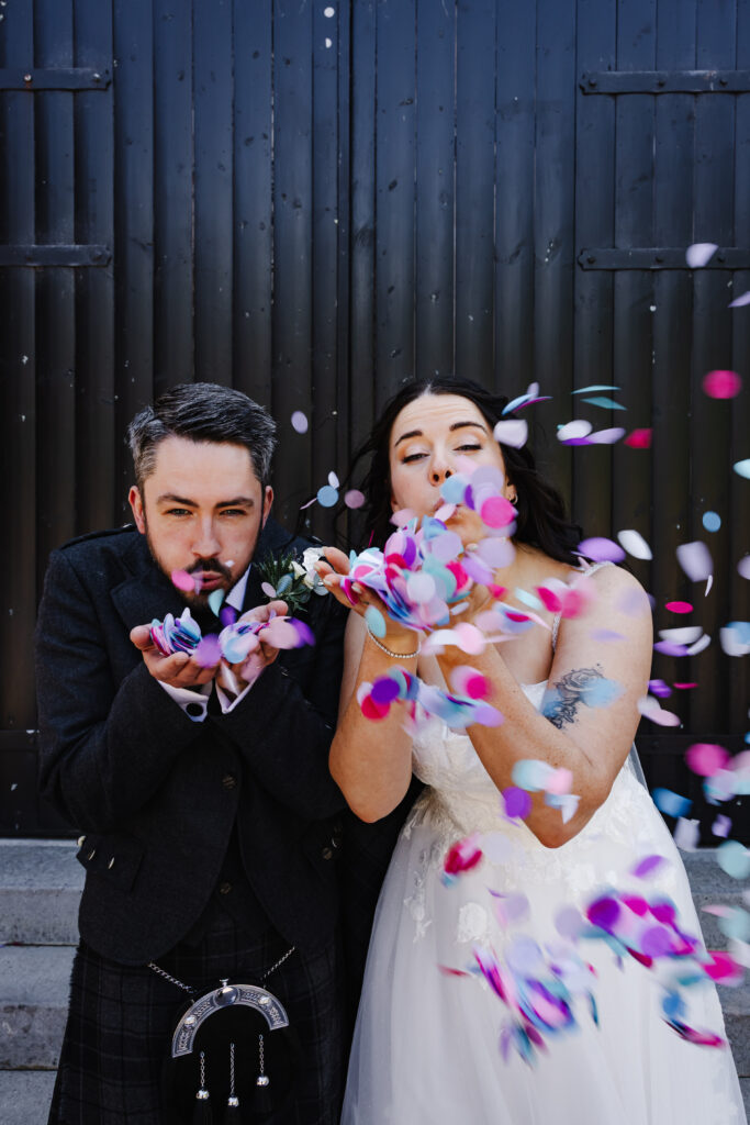 Bride and Groom blow confetti at The Engine Works Glasgow