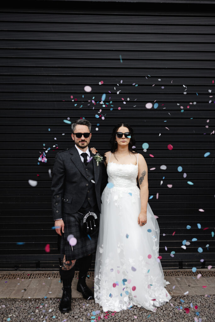 Bride and Groom in sunglasses with confetti at The Engine Works Glasgow