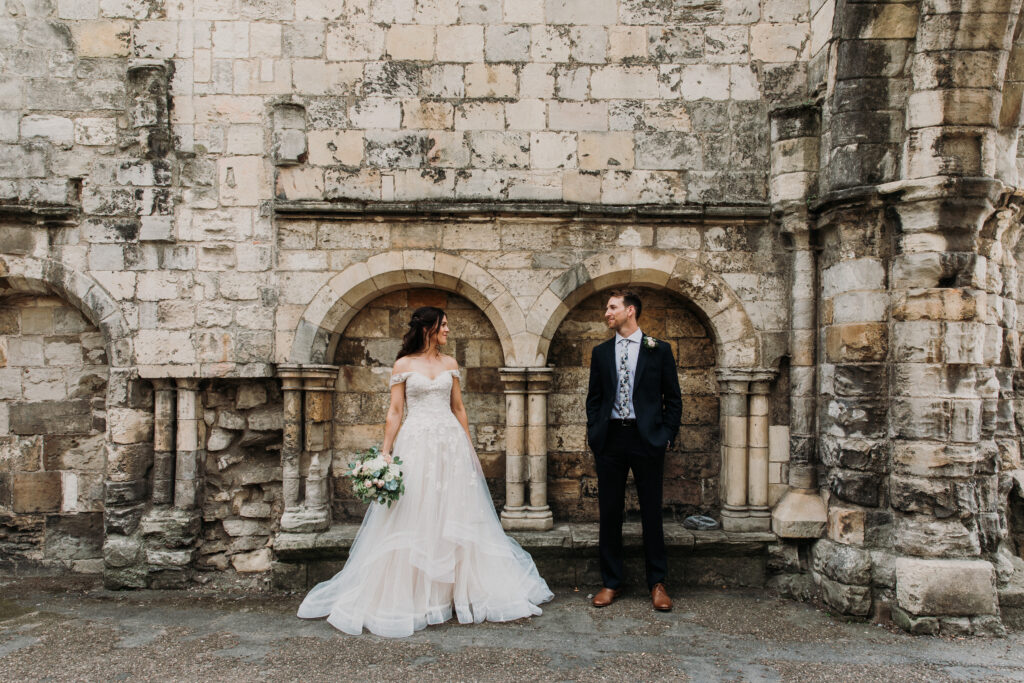 Bride and Groom in front of wall in York Museum Gardens